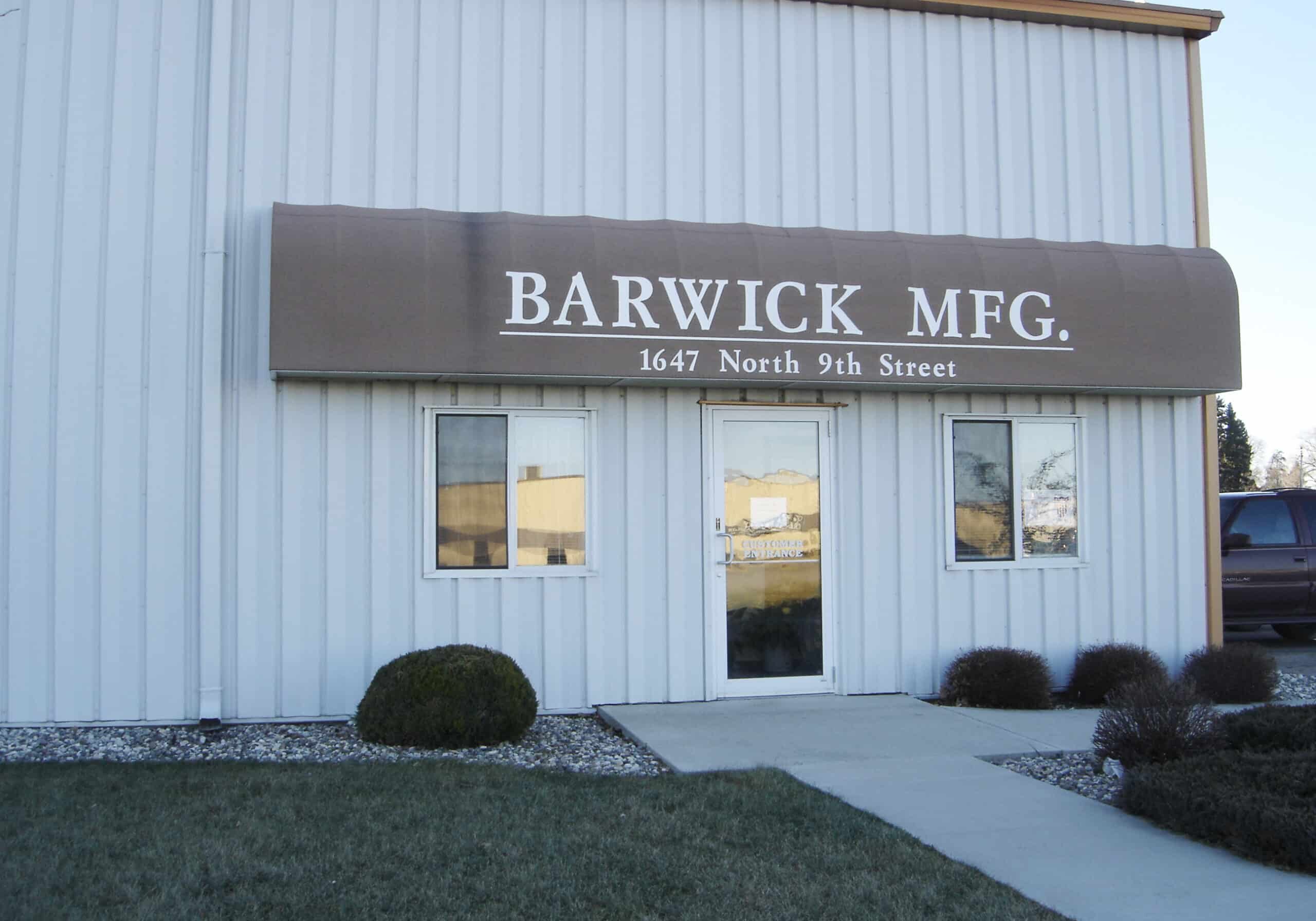 white and beige barwick mfg building