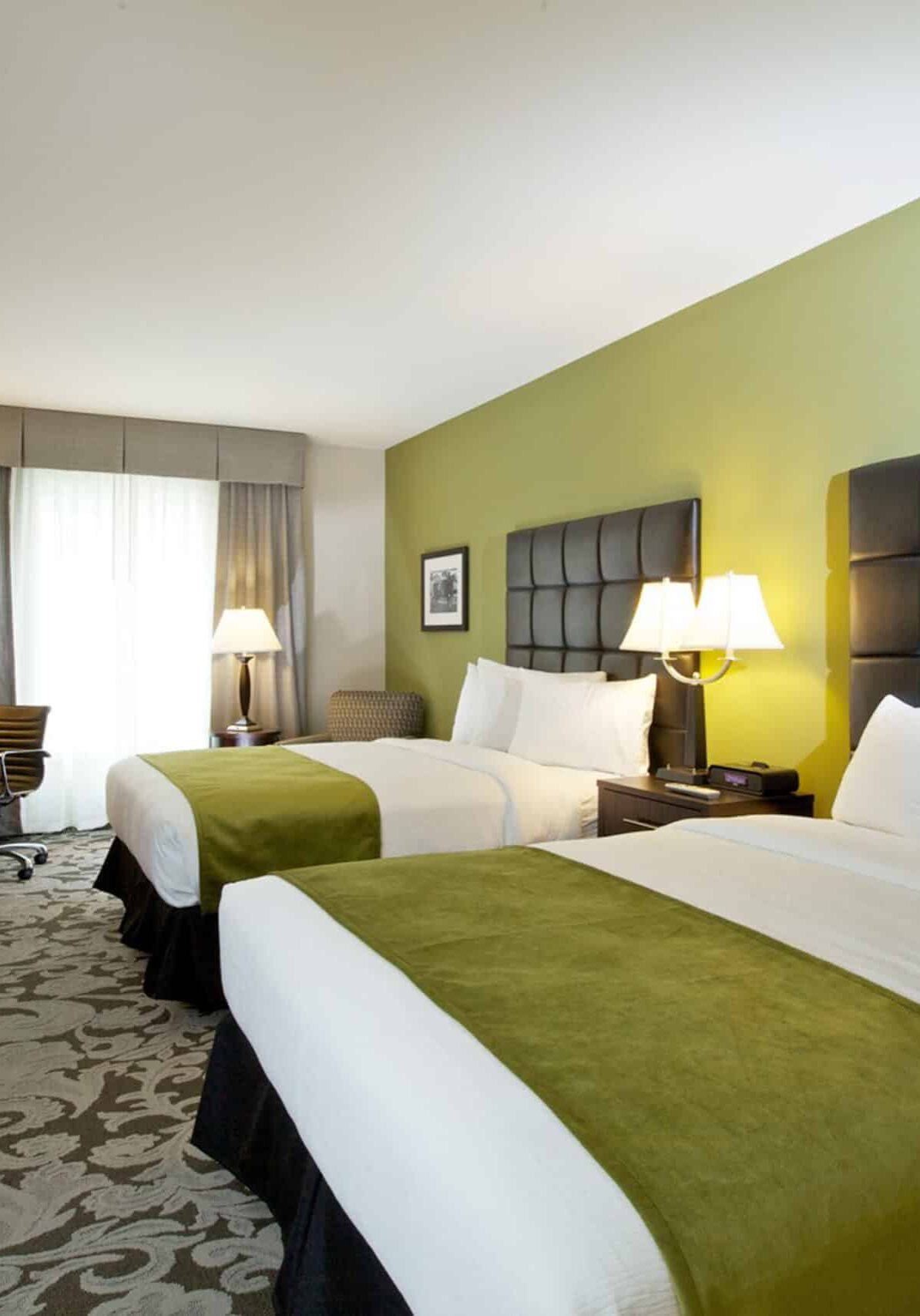 double queen beds hotel room with drapes