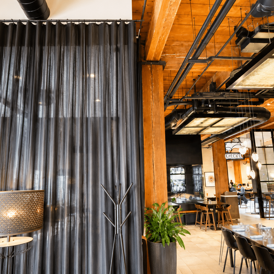 drapes hanging in hotel dining area as a room divider