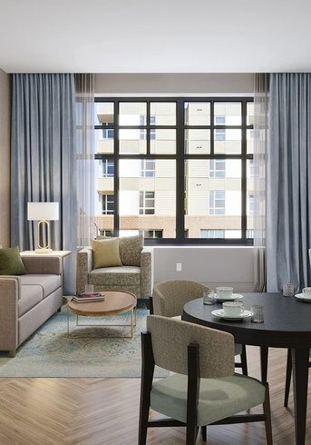 living room with light curtains, white couch and small dining table